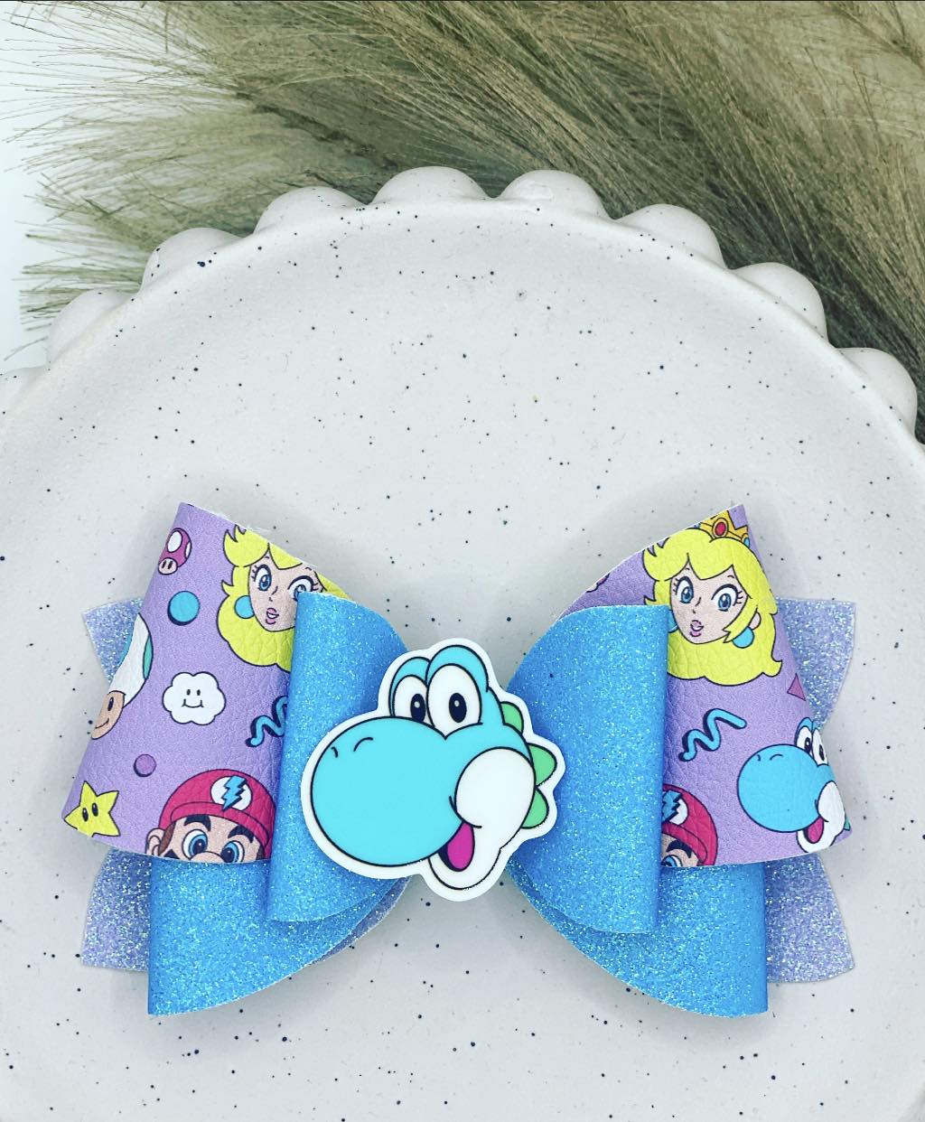 Aqua Dinosaur 'Pebbles Planar Bow'